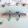 easyReadingTurquoiseCracker Image of sample of DIY Personalised Christmas Cracker in turquoise with name in easy-reading font